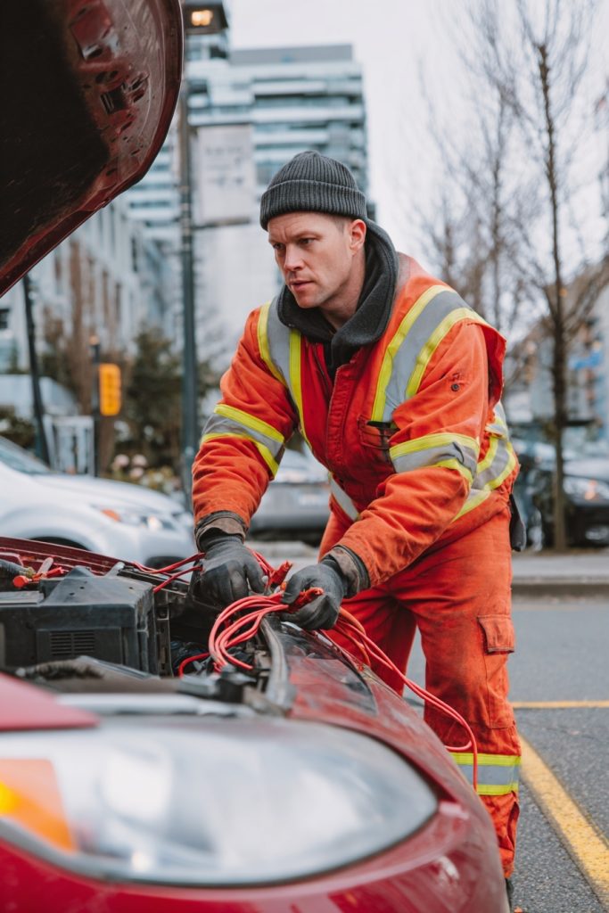 Car receiving a Battery Boost (Jump Start) from a roadside technician
